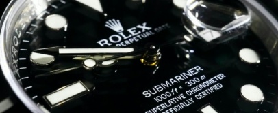 Close-up of a black Rolex Submariner Date dial and ceramic bezel