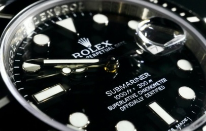 Close-up of a black Rolex Submariner Date dial and ceramic bezel