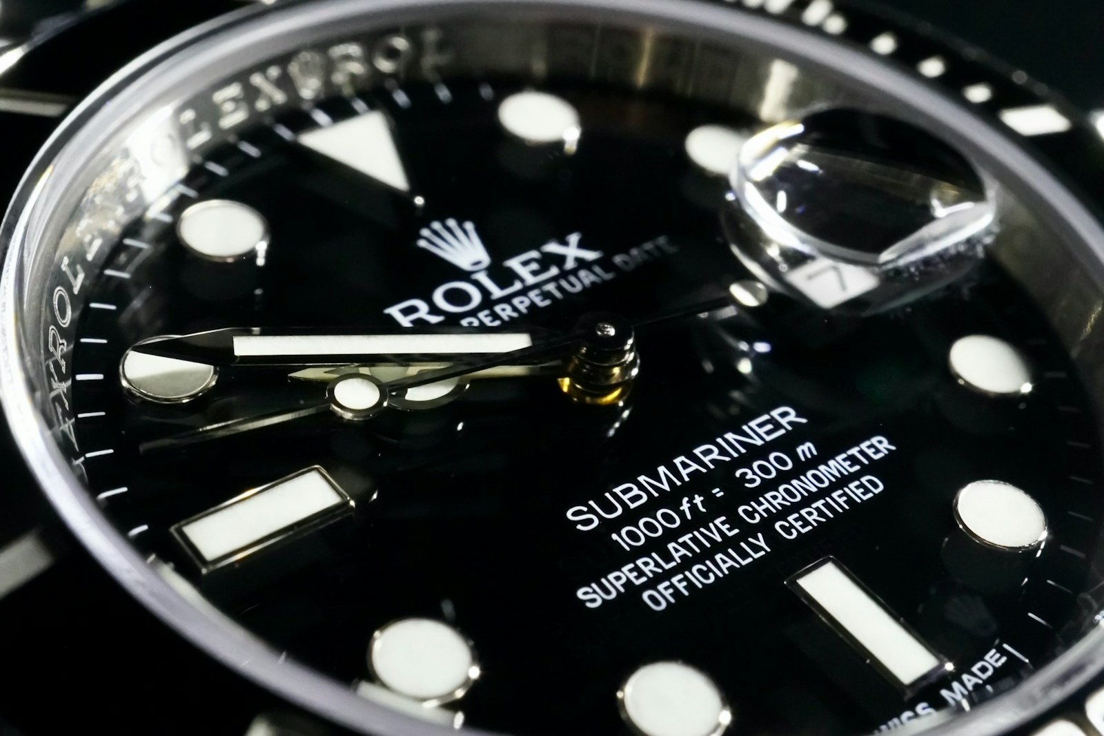 Close-up of a black Rolex Submariner Date dial and ceramic bezel