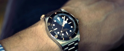 Tudor Black Bay with black dial and gilt bezel markings on a steel bracelet, on the wrist